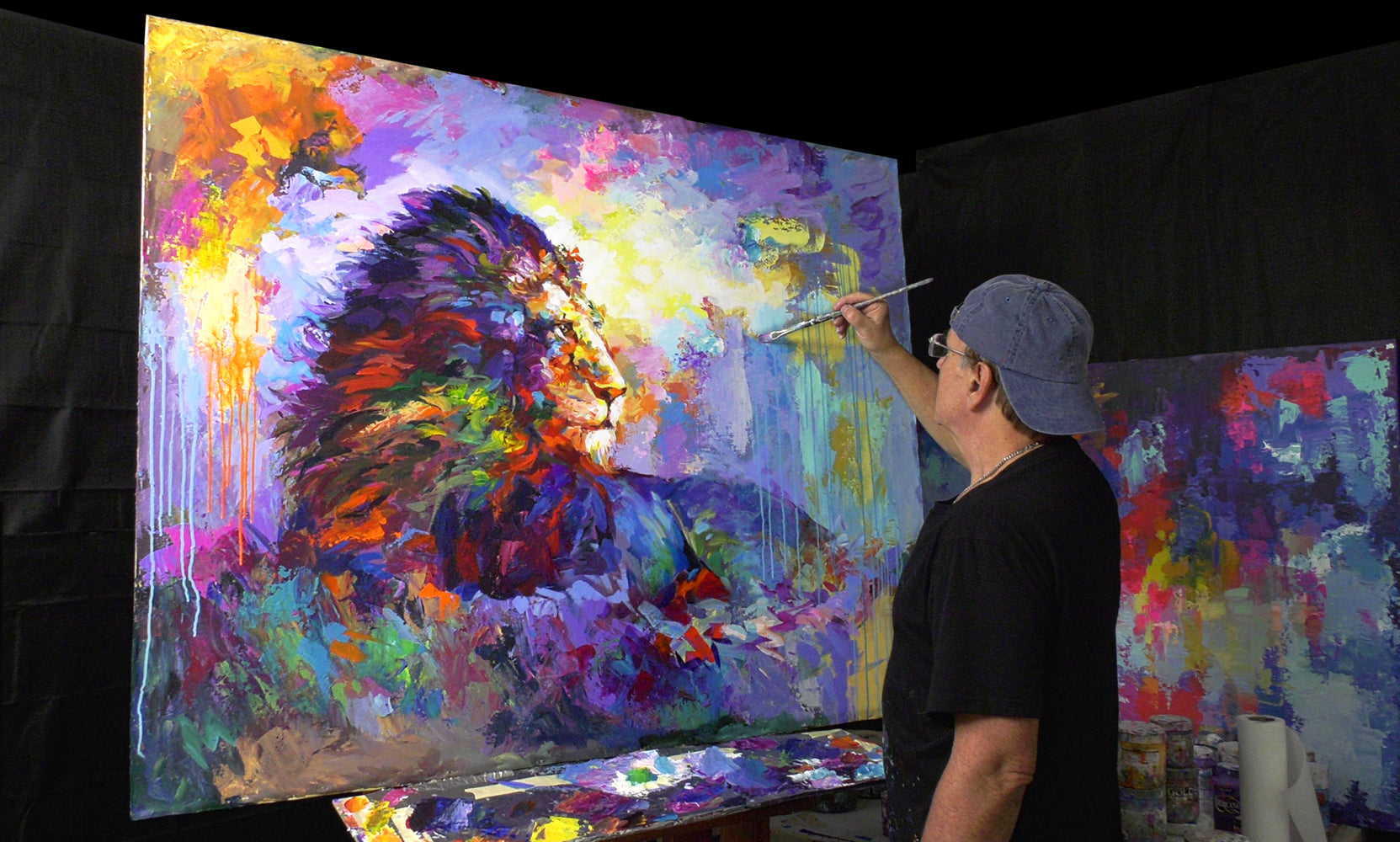 Leon Devenice painting a lion